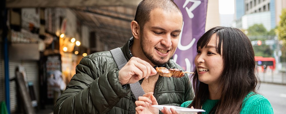 Couple enjoying street food skewers